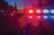 Red and blue Lights of police car in night time. Night patrolling the city. Abstract blurry image.